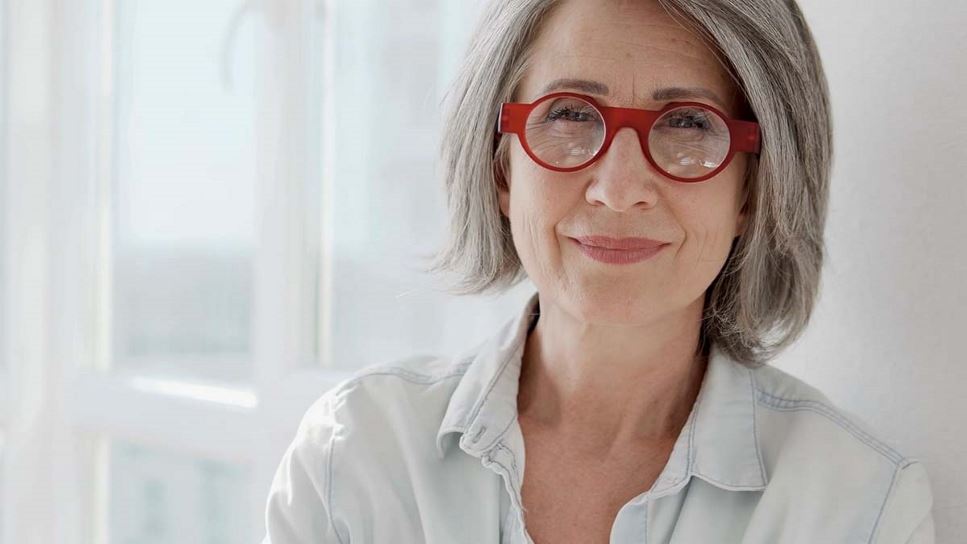 Healthy Habits to Help Ease Menopause Symptoms | Older Woman with Glasses Looking into Camera